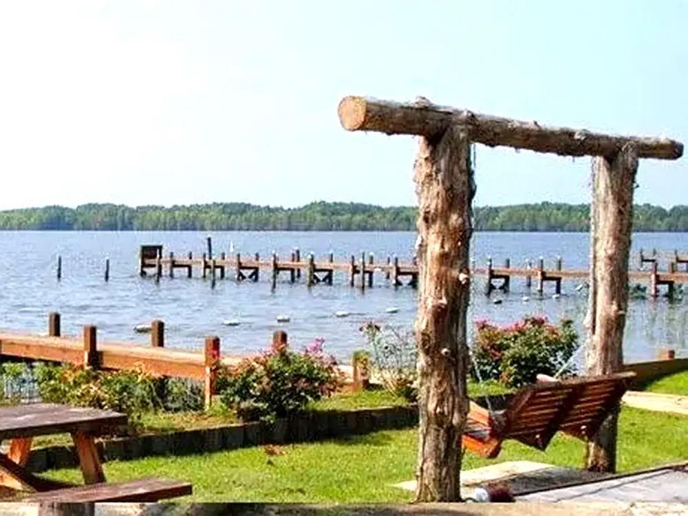 Rustic swings overlooking Lake Marion and two of Relaxed Retreat at Carolina King's seven piers.